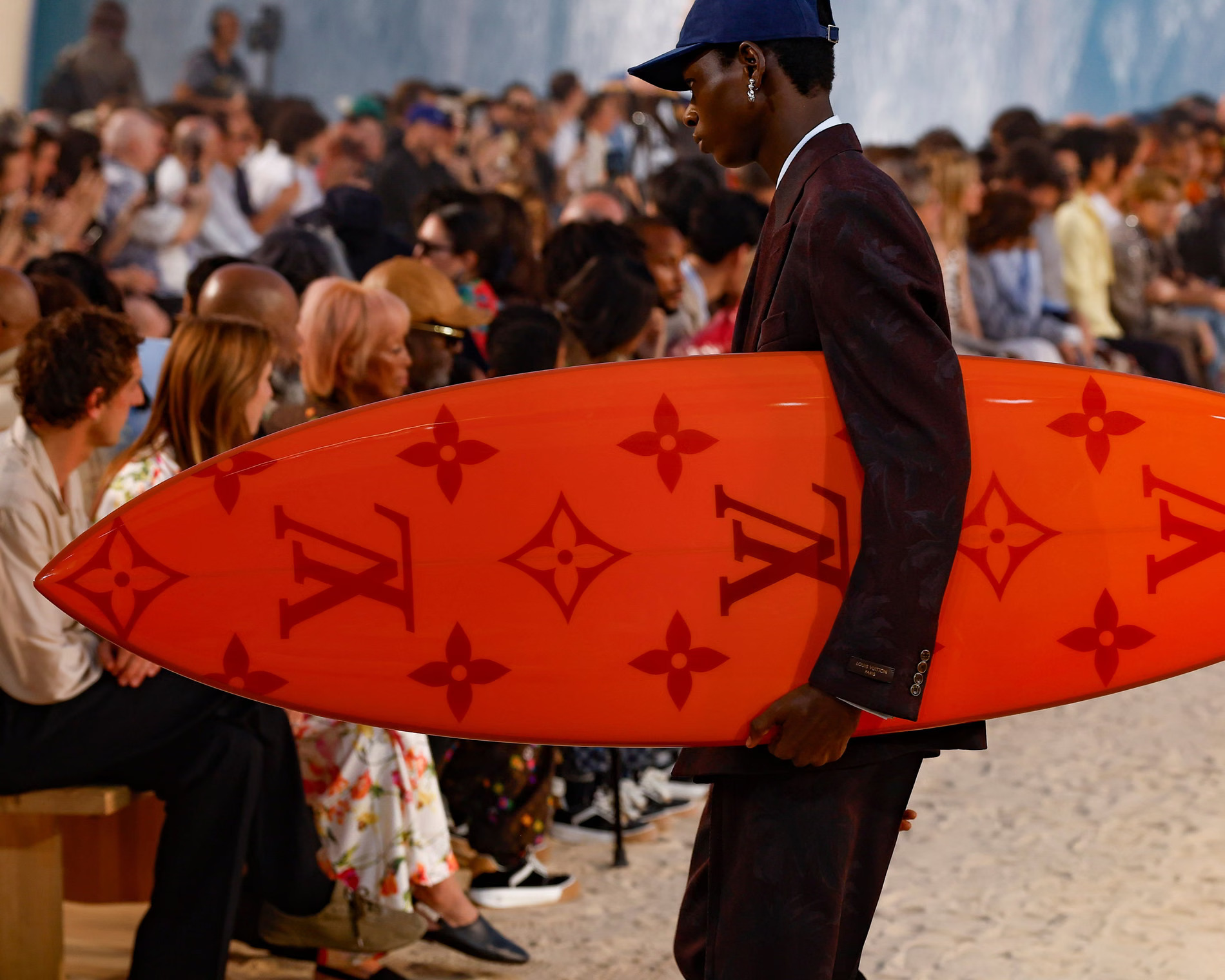 Model on the Louis Vuitton Spring/Summer 2027 runway carrying a monogrammed surfboard